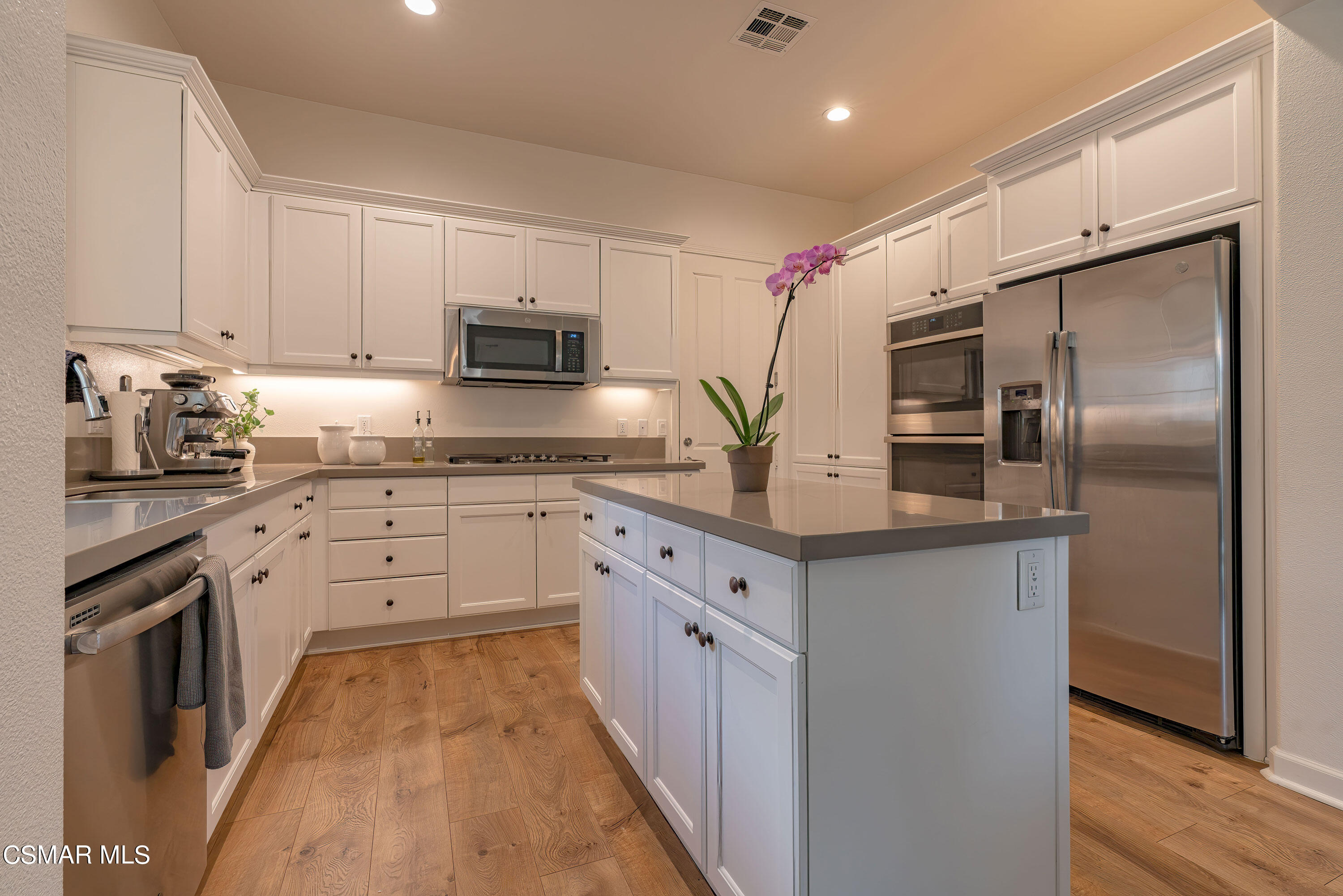1614 Range Road Oxnard, CA 93036 - Photo 7 of 26 a kitchen with granite countertop white cabinets and stainless steel appliances