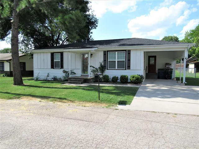 a front view of house with yard and green space
