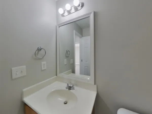 a bathroom with a sink mirror and vanity