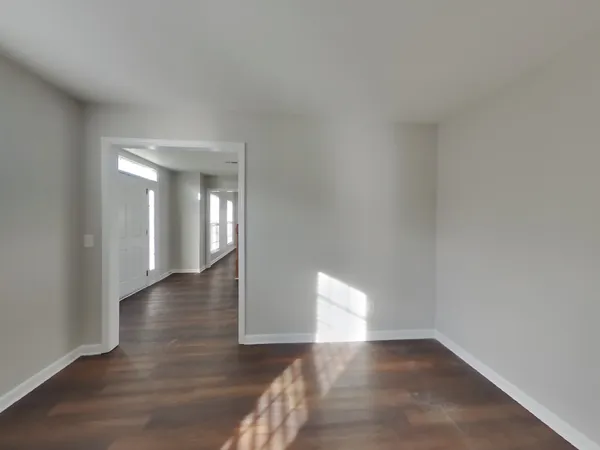 a view of an empty room and wooden floor