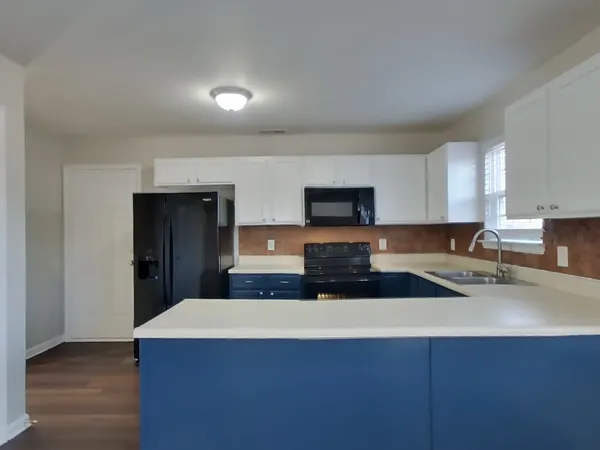 a kitchen with stainless steel appliances a sink stove and cabinets