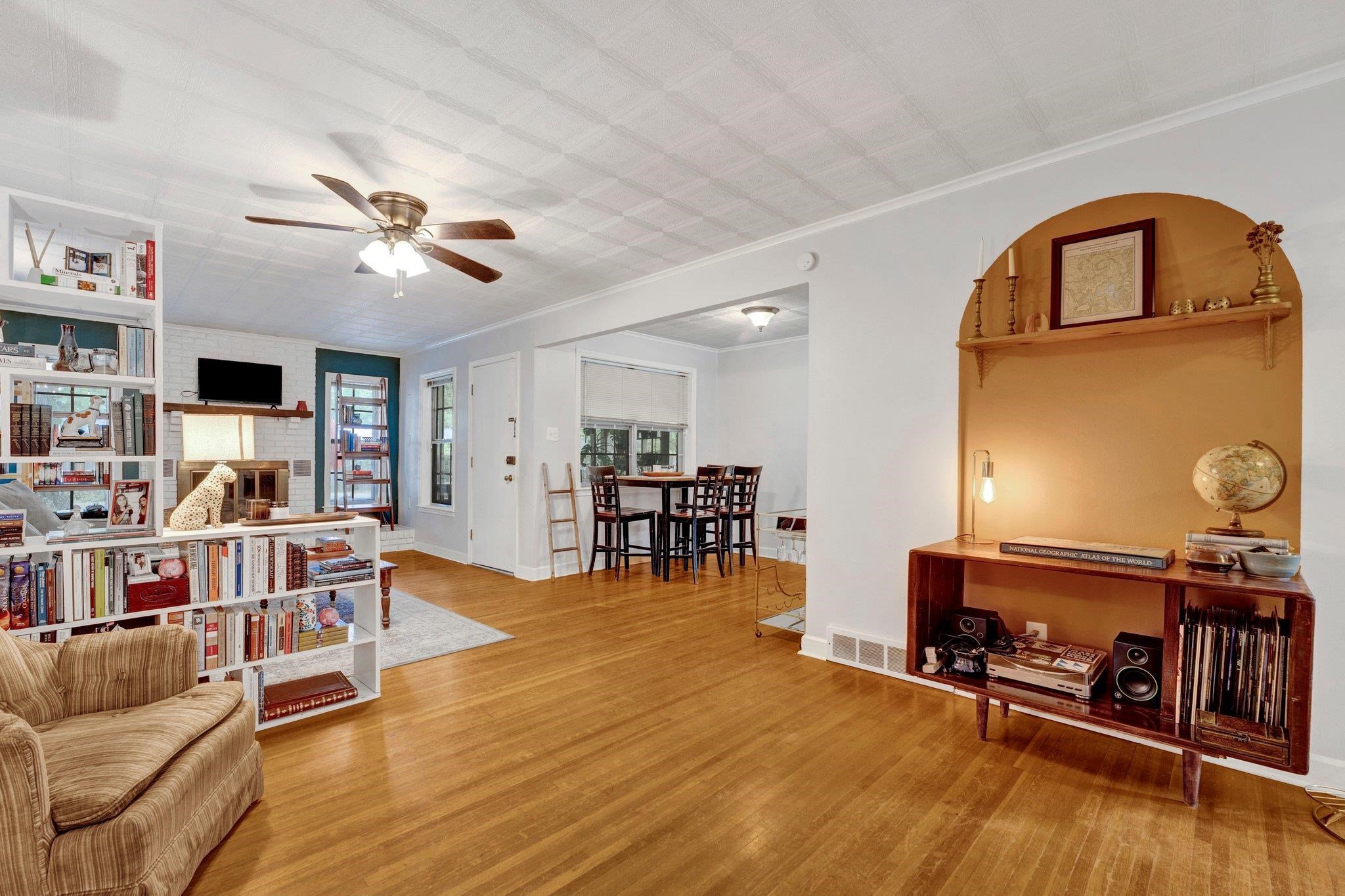 4500 East Dearing Road Memphis, TN 38117 - Photo 3 of 18 Sitting room with crown molding, a fireplace, ceiling fan, and light hardwood / wood-style floors