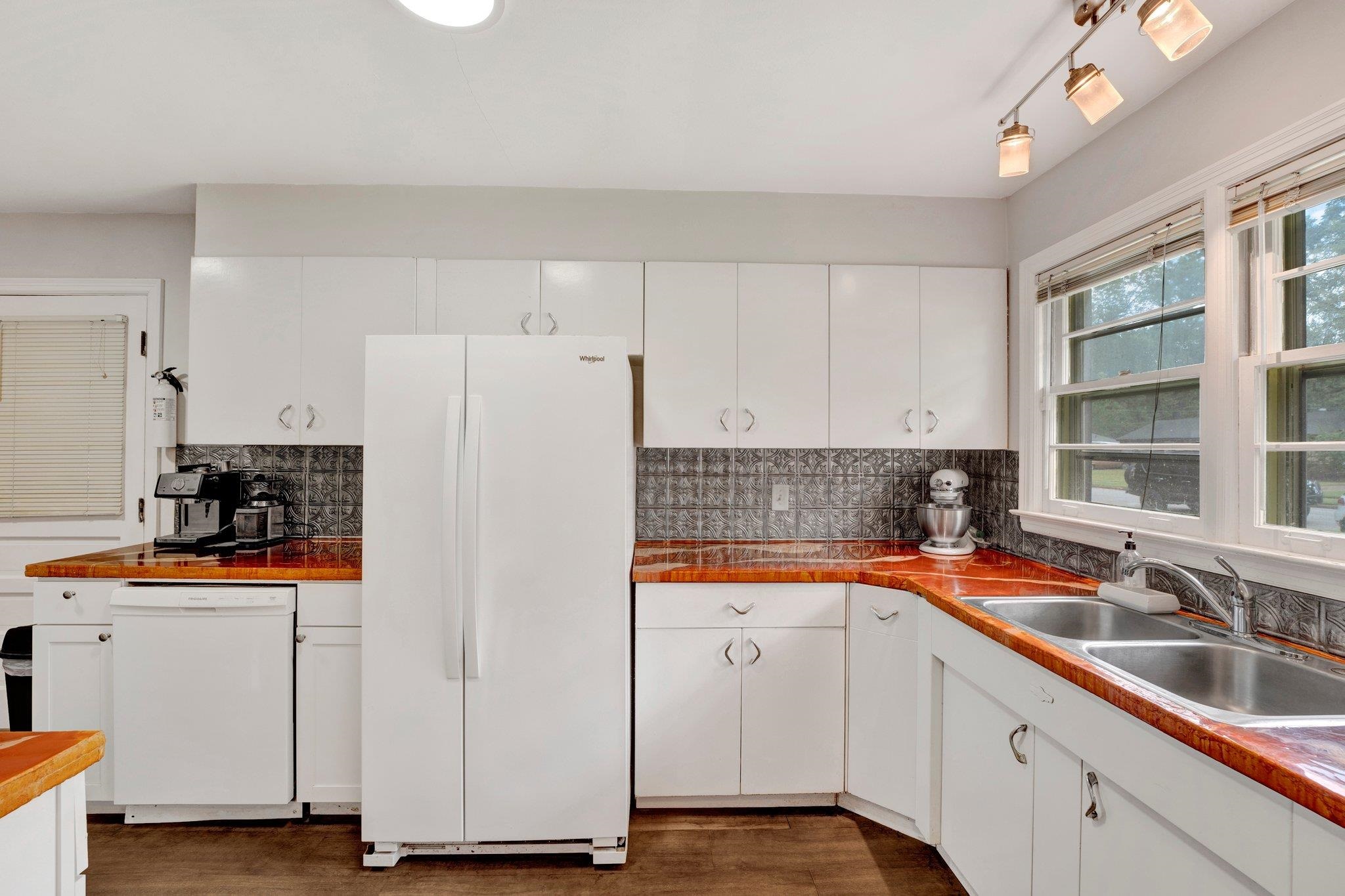 4500 East Dearing Road Memphis, TN 38117 - Photo 6 of 18 Kitchen featuring sink, white appliances, white cabinets, and tasteful backsplash