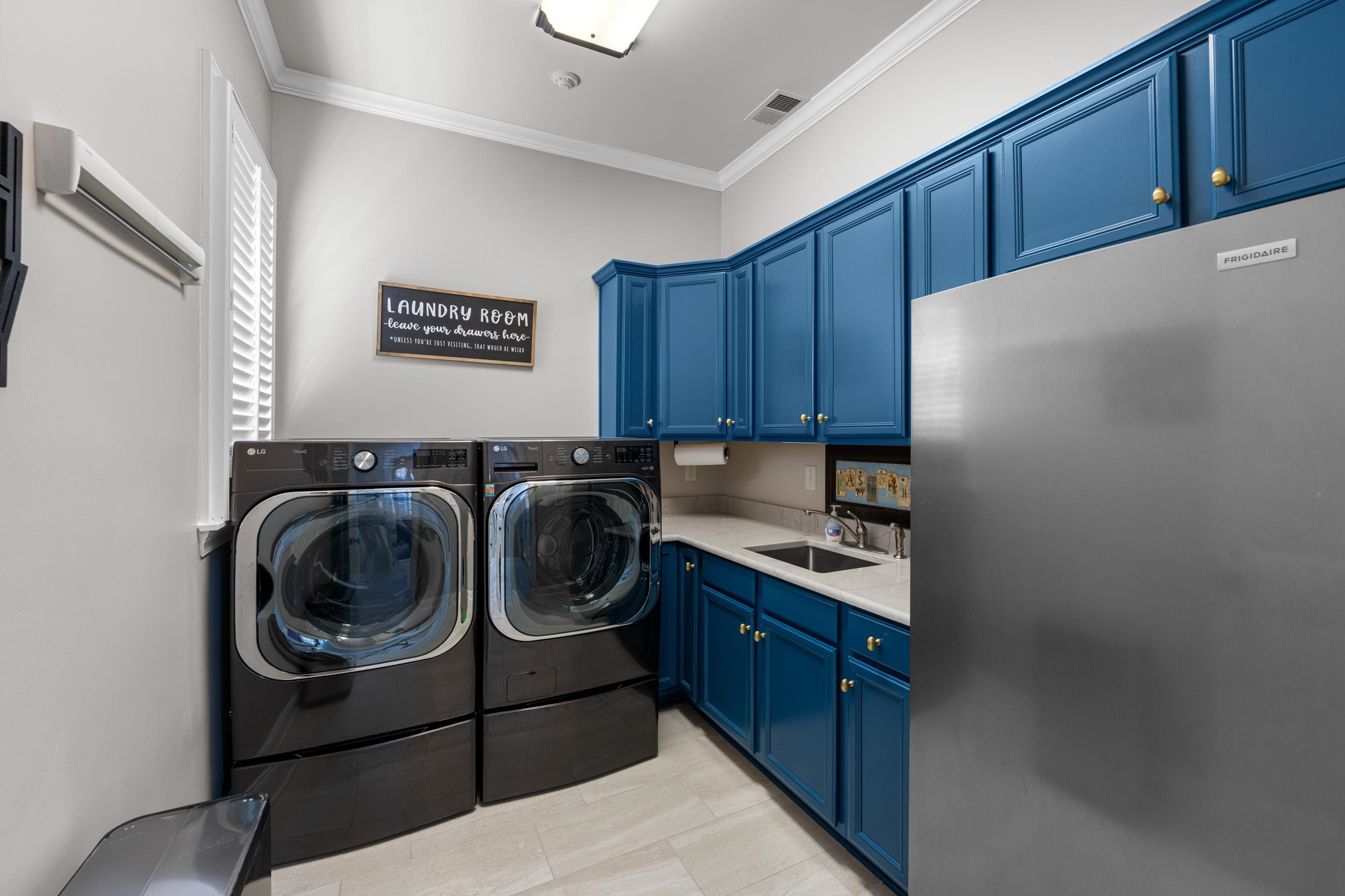 300 Windover Road Piperton, TN 38017 - Photo 22 of 40 Nice size laundry with sink and lots of cabinet for storage.