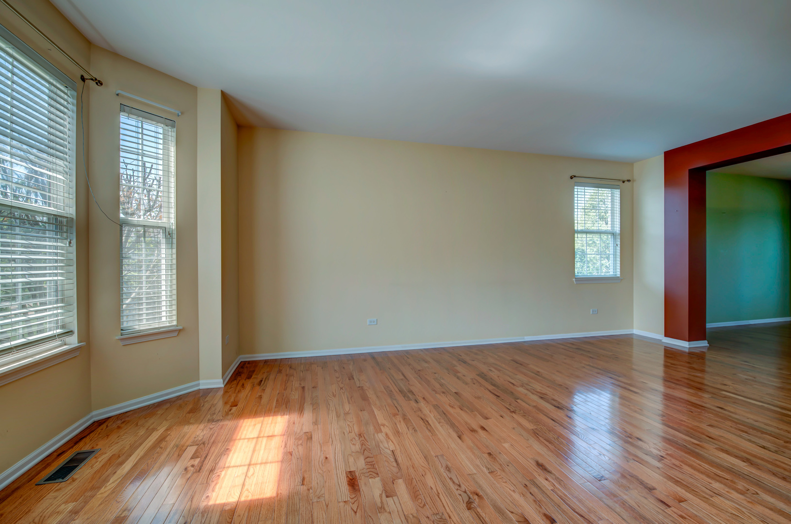 860 Spring Creek Circle Naperville, IL 60565 - Photo 4 of 26 an empty room with wooden floor and windows