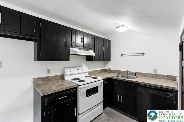a kitchen with stainless steel appliances granite countertop a sink stove and cabinets