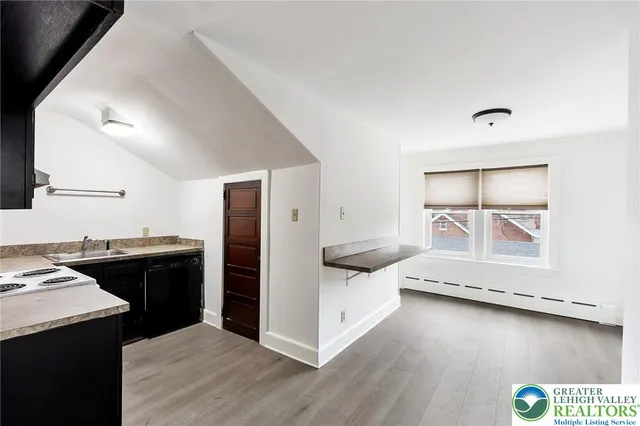 a kitchen with a stove and a refrigerator