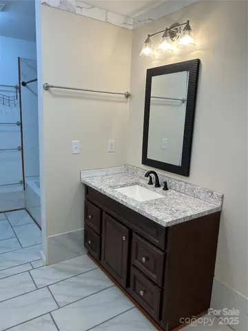 a bathroom with a glass door shower