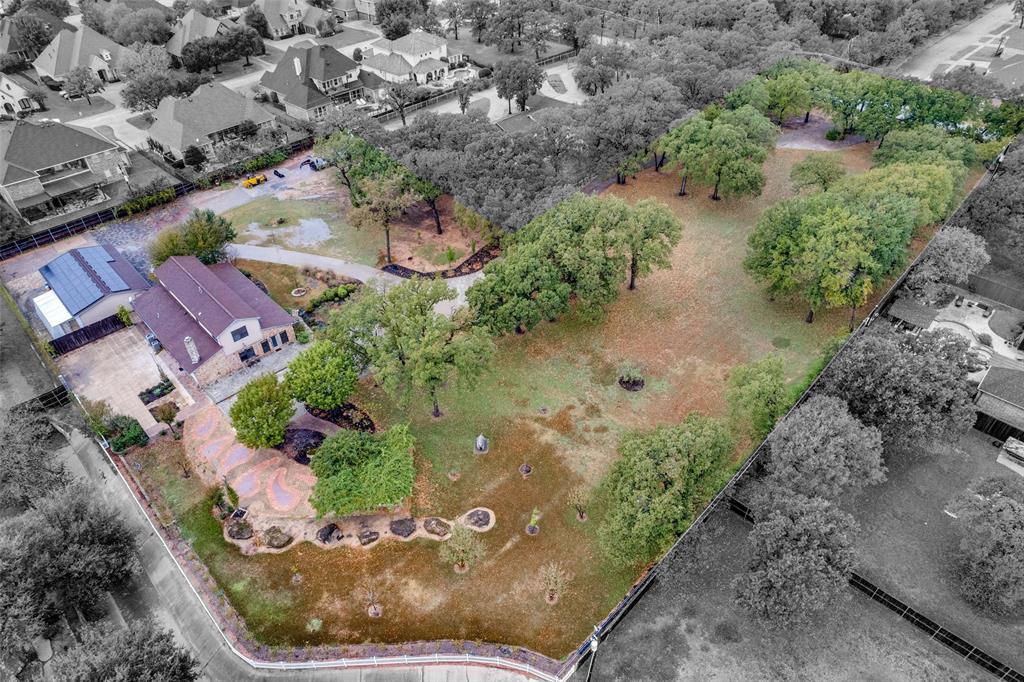 an aerial view of a house with a yard and lake view