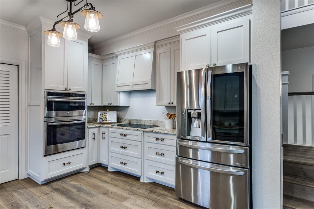 950 Turner Way Mansfield, TX 76063 - Photo 11 of 29 a kitchen with stainless steel appliances a refrigerator sink and cabinets
