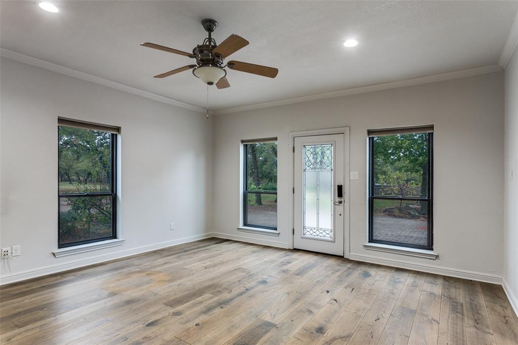 950 Turner Way Mansfield, TX 76063 - Photo 4 of 29 a view of an empty room with a window and wooden floor