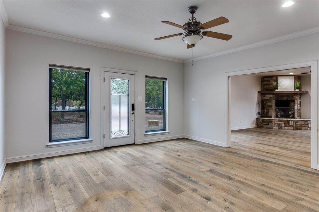 950 Turner Way Mansfield, TX 76063 - Photo 5 of 29 an empty room with wooden floor and a ceiling fan