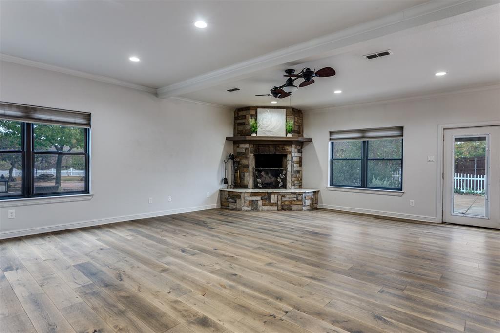 950 Turner Way Mansfield, TX 76063 - Photo 6 of 29 an empty room with windows fireplace and cabinet