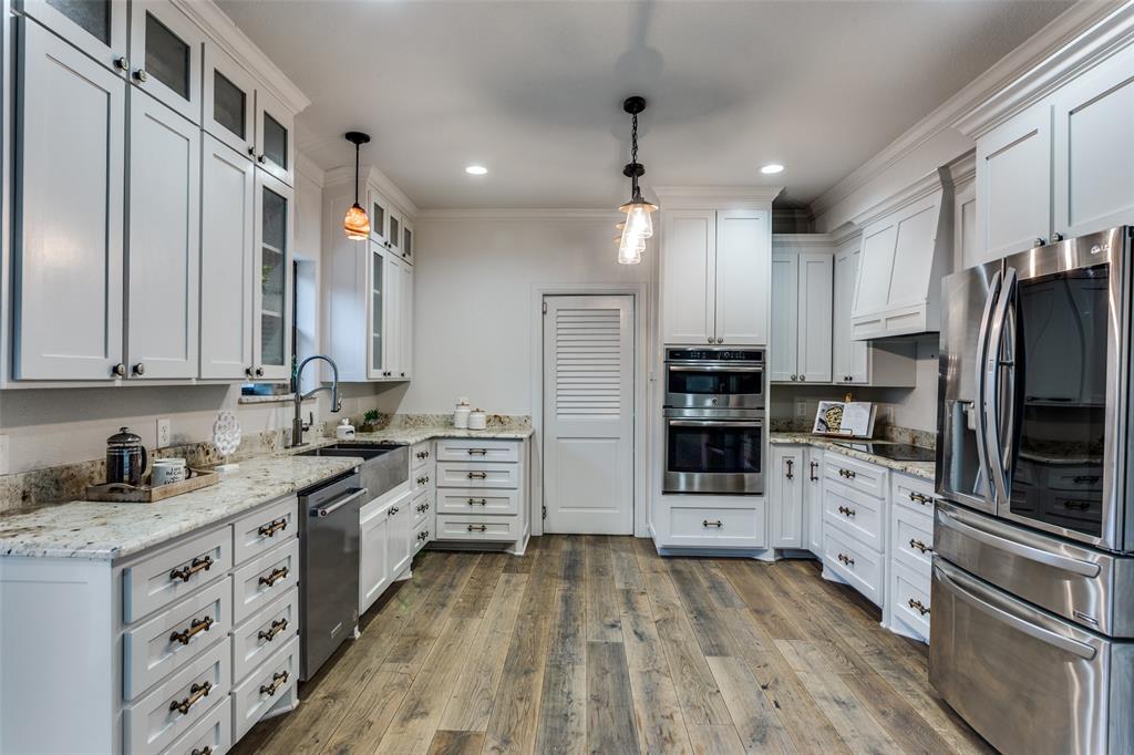 950 Turner Way Mansfield, TX 76063 - Photo 9 of 29 a kitchen with stainless steel appliances a refrigerator sink and stove top oven