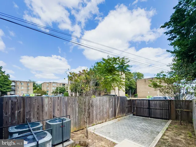 a view of a backyard with wooden fence