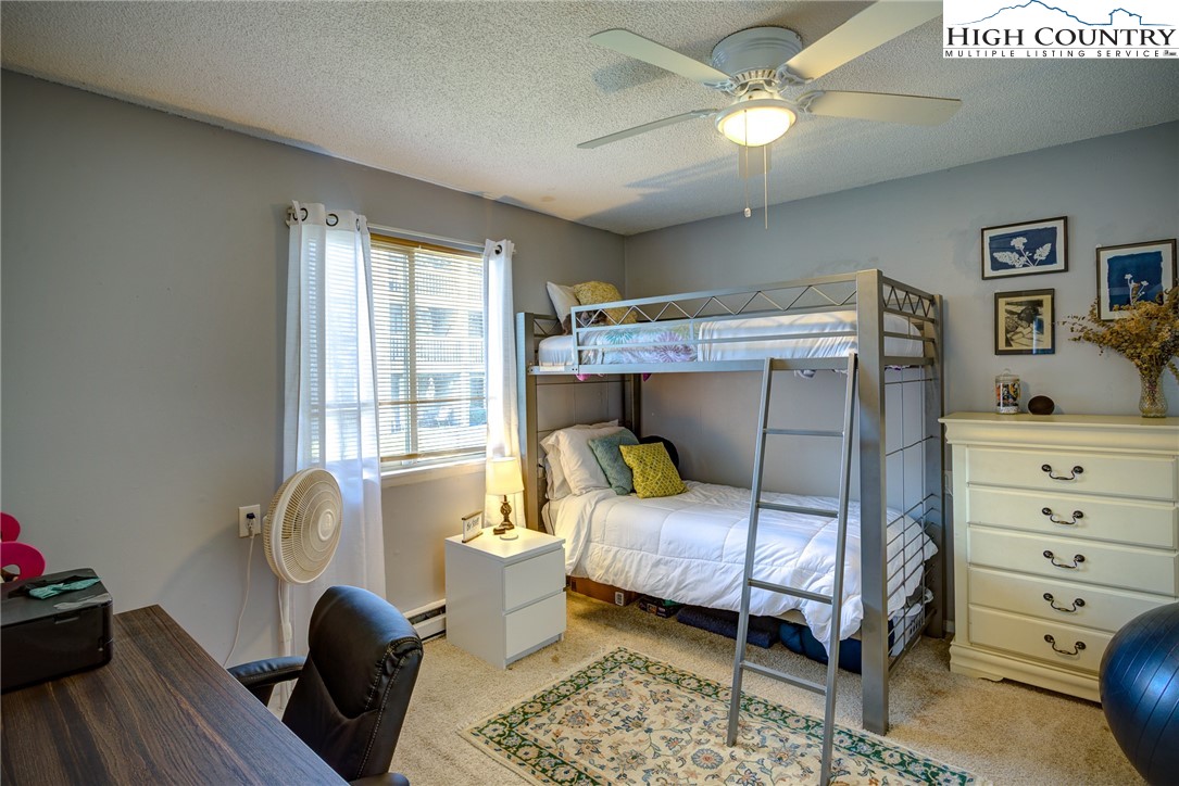 160 Zeb Street, Unit C104 Boone, NC 28607 - Photo 11 of 21 a bedroom with a bed and wooden floor