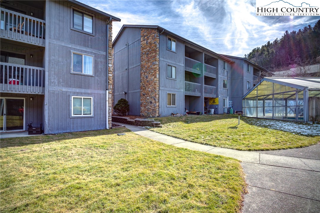 160 Zeb Street, Unit C104 Boone, NC 28607 - Photo 14 of 21 a view of a brick building next to a yard