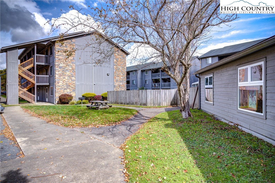 160 Zeb Street, Unit C104 Boone, NC 28607 - Photo 16 of 21 a backyard of a house with wooden fence and large trees