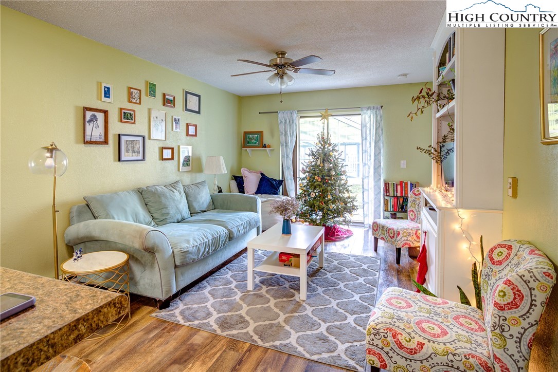 160 Zeb Street, Unit C104 Boone, NC 28607 - Photo 3 of 21 a living room with furniture and a large window