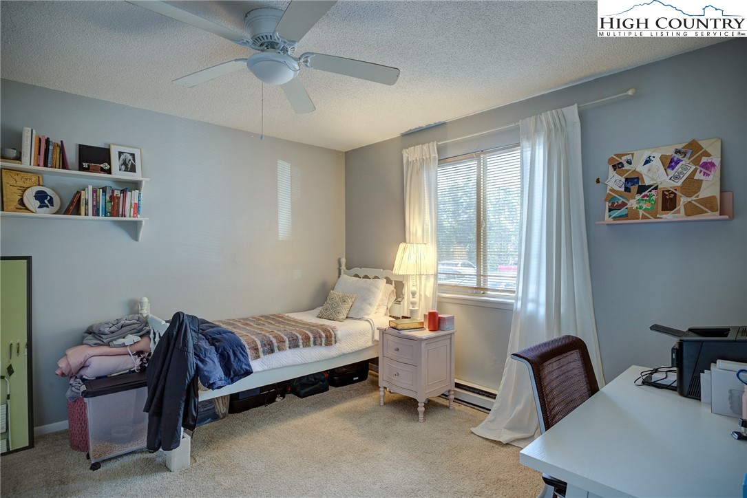 160 Zeb Street, Unit C104 Boone, NC 28607 - Photo 6 of 21 a bedroom with furniture and a window