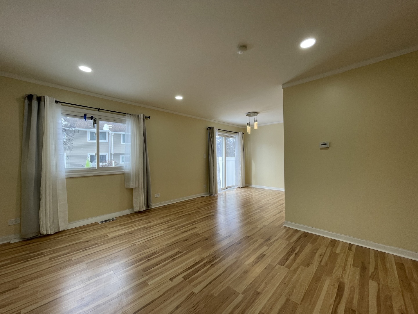 1105 Sandpiper Court Bartlett, IL 60103 - Photo 2 of 28 a view of an empty room with wooden floor and a window
