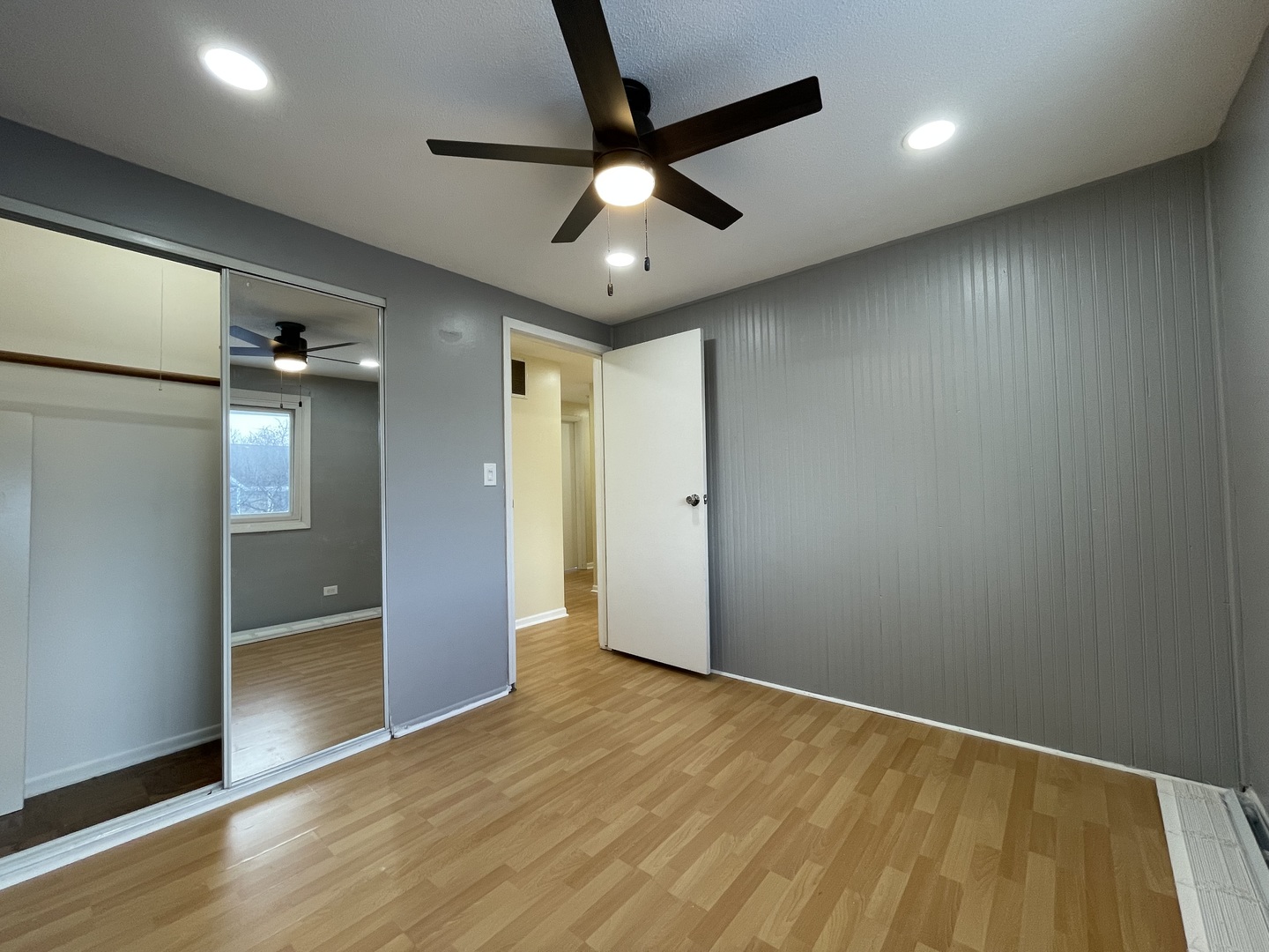 1105 Sandpiper Court Bartlett, IL 60103 - Photo 21 of 28 an empty room with wooden floor and a ceiling fan