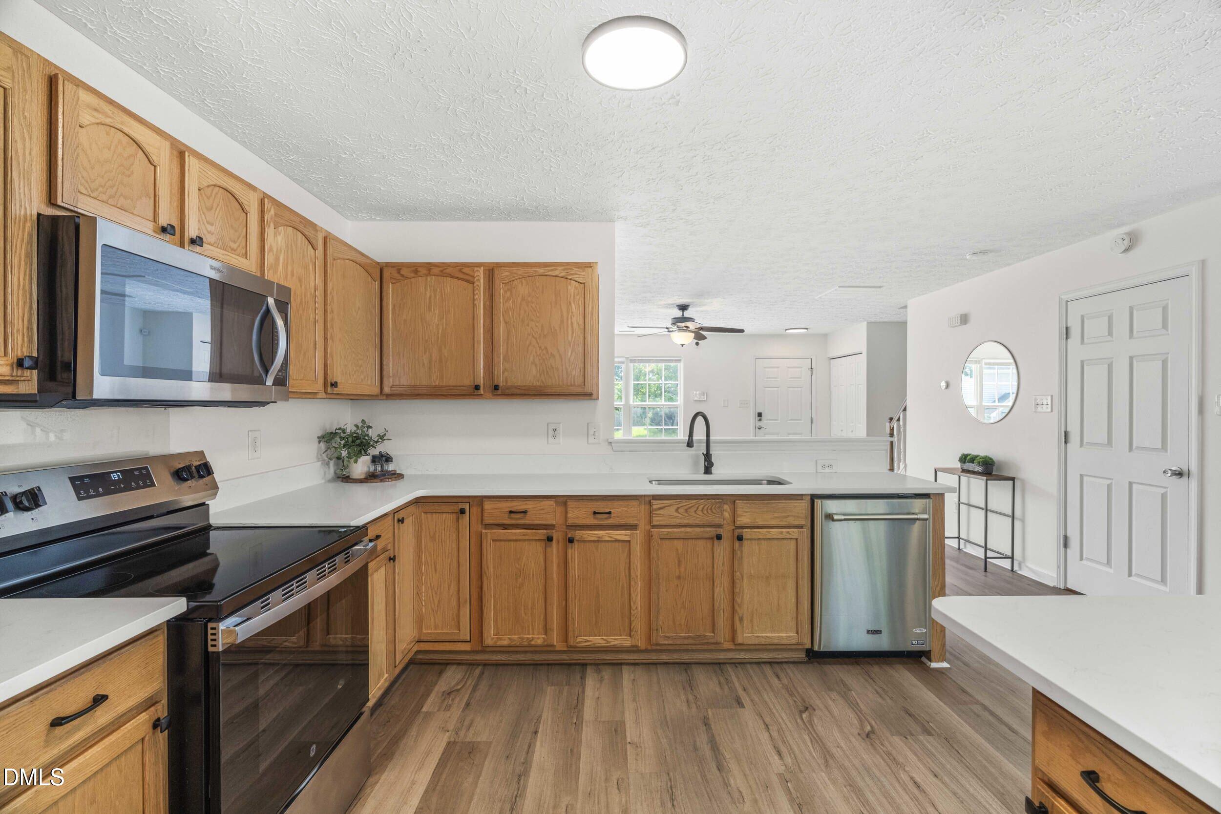 4121 Tensity Drive Raleigh, NC 27604 - Photo 4 of 34 Kitchen with stainless range, built-in microwave and dishwasher