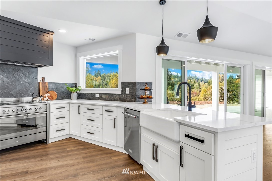 3222 Creswell Road Snohomish, WA 98290 - Photo 19 of 36 a kitchen with stainless steel appliances white cabinets and a sink