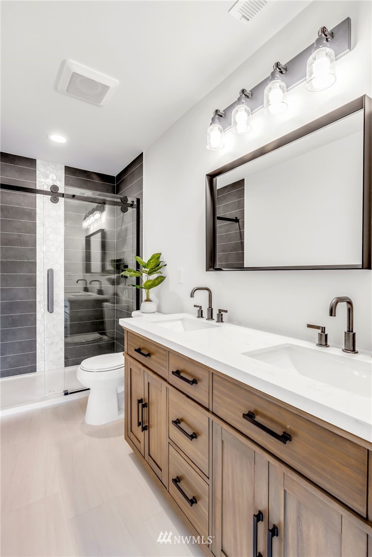 3222 Creswell Road Snohomish, WA 98290 - Photo 23 of 36 a bathroom with a granite countertop sink a toilet a large mirror and shower