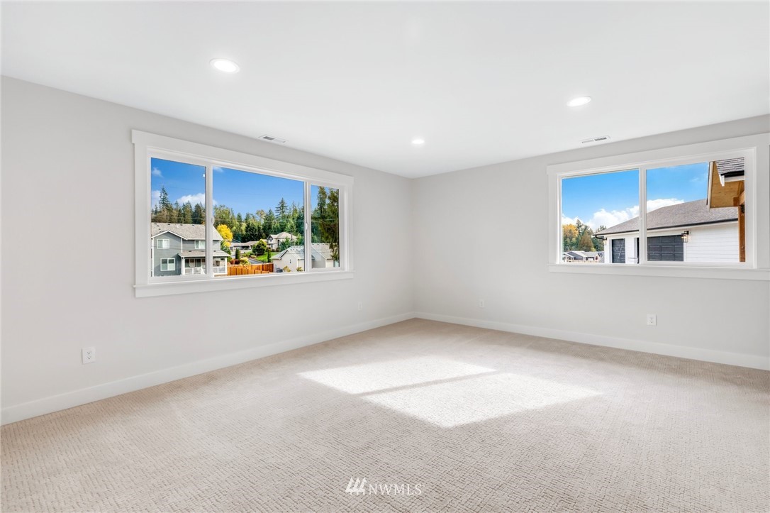 3222 Creswell Road Snohomish, WA 98290 - Photo 26 of 36 an empty room with windows and fireplace