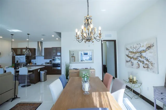 a living room with kitchen island furniture and a chandelier