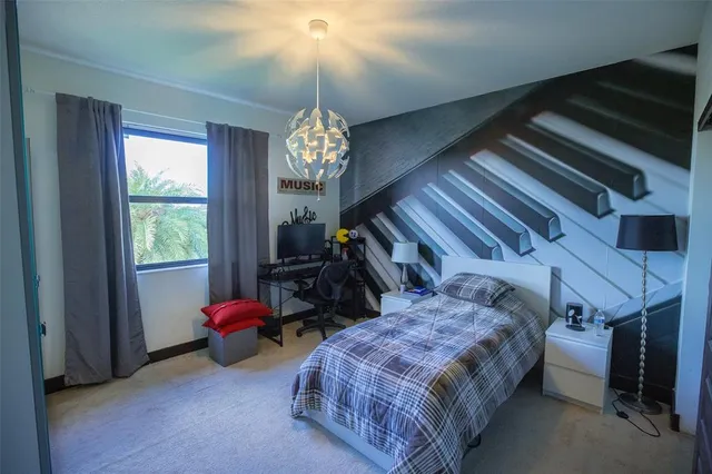 a bedroom with bed and a chandelier