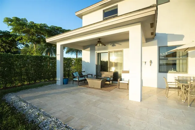 a view of a patio with table and chairs and potted plants
