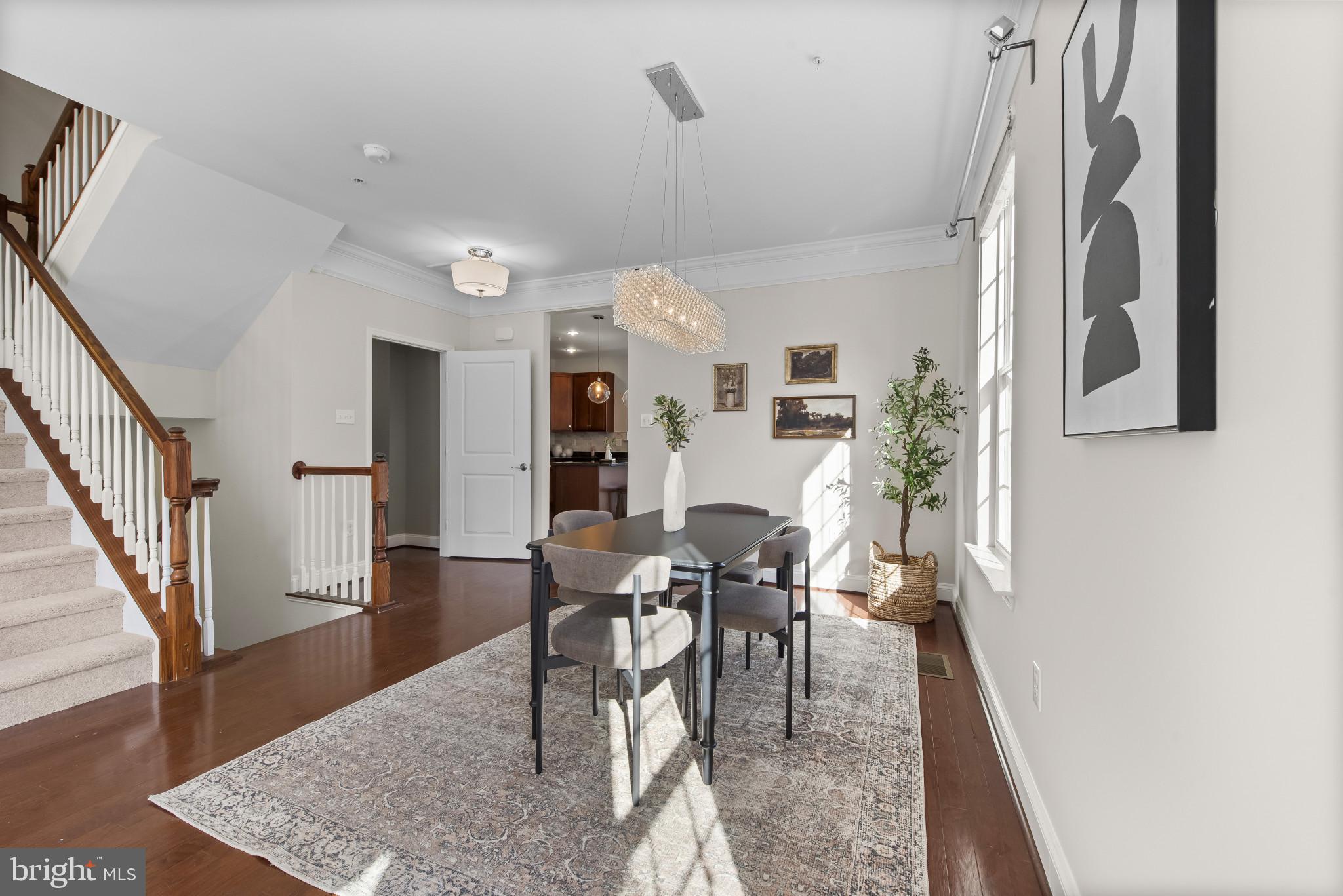 5948 Logans Way Ellicott City, MD 21043 - Photo 13 of 44 a view of a dining room with furniture and wooden floor