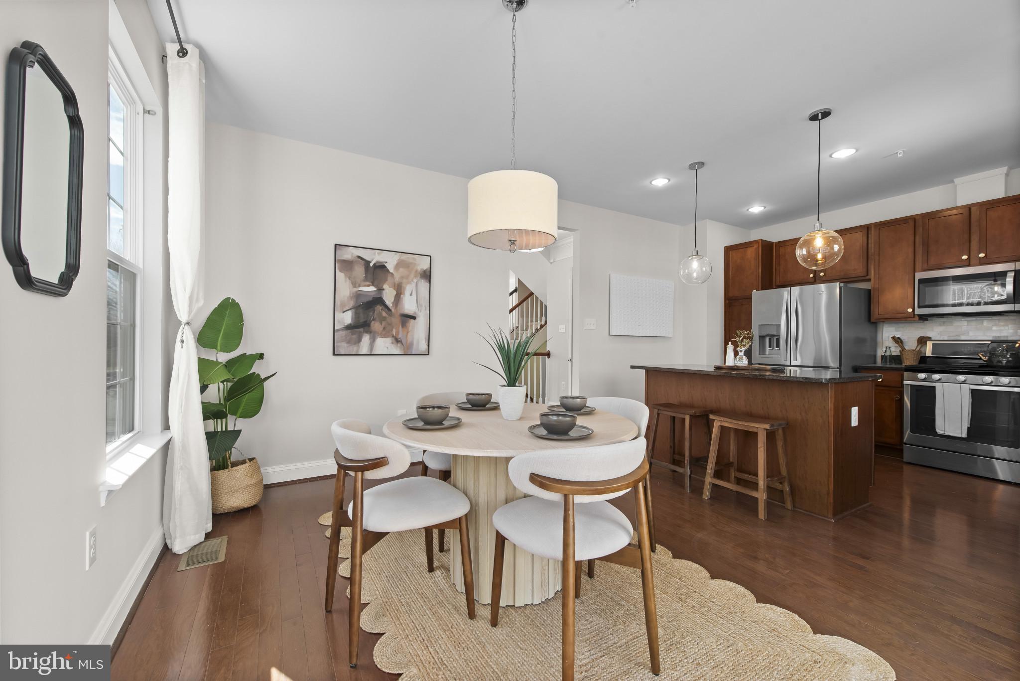 5948 Logans Way Ellicott City, MD 21043 - Photo 22 of 44 a view of a dining room with furniture wooden floor and chandelier