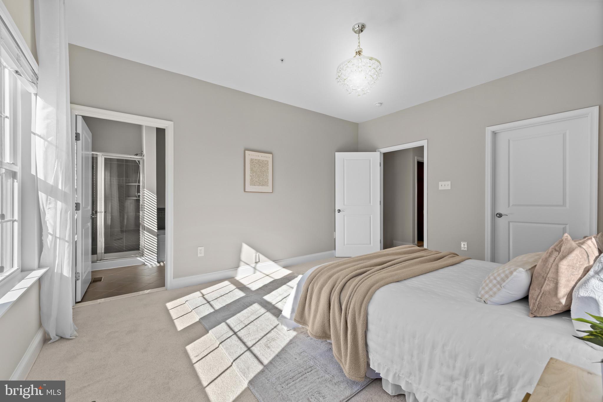 5948 Logans Way Ellicott City, MD 21043 - Photo 28 of 44 a bedroom with a bed and a chandelier