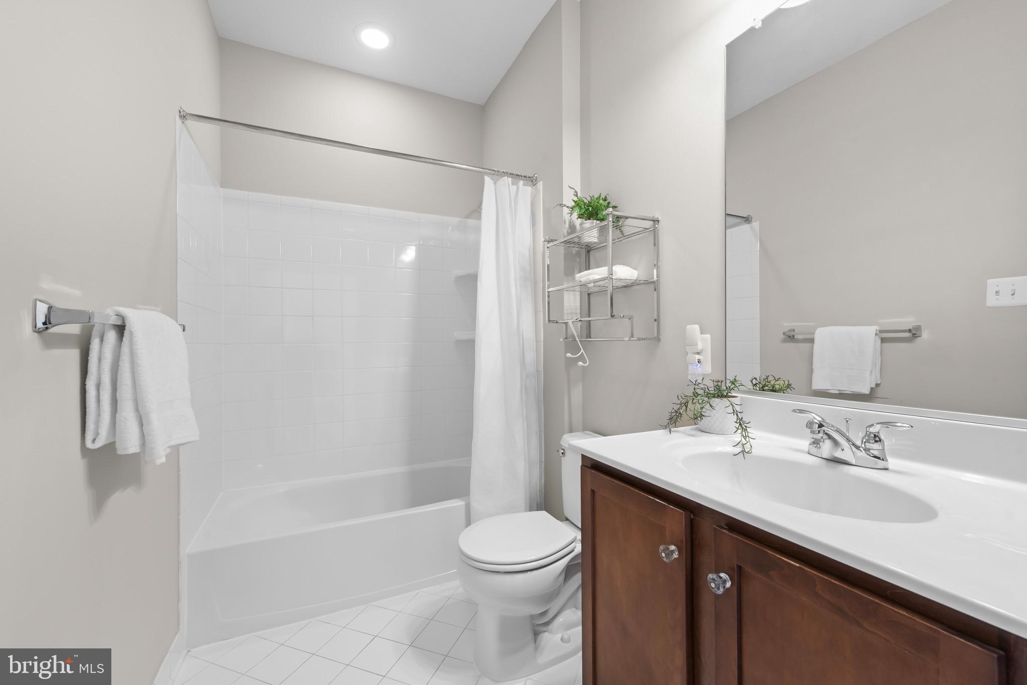 5948 Logans Way Ellicott City, MD 21043 - Photo 32 of 44 a bathroom with a sink a toilet and shower