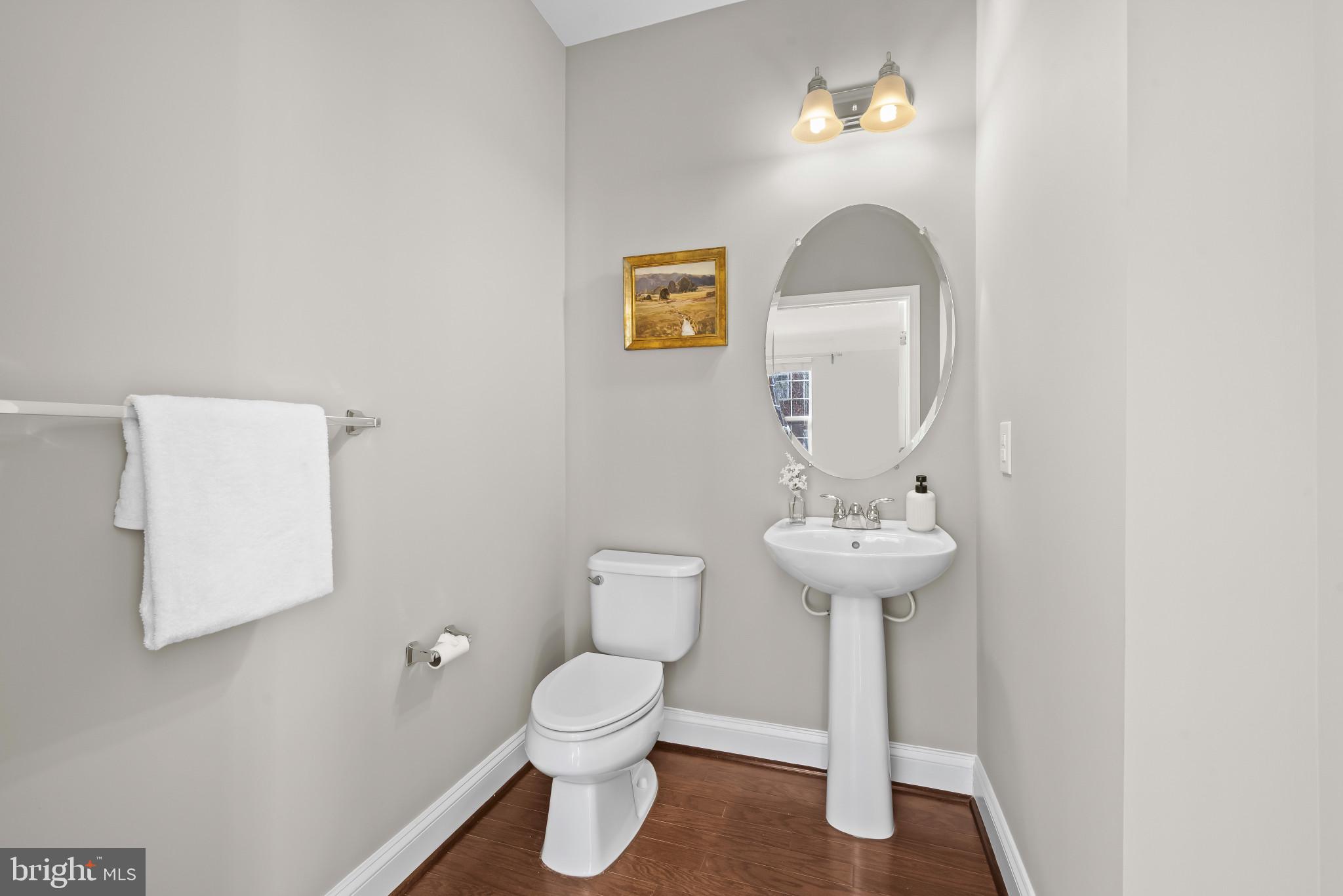 5948 Logans Way Ellicott City, MD 21043 - Photo 8 of 44 a bathroom with a toilet sink and mirror