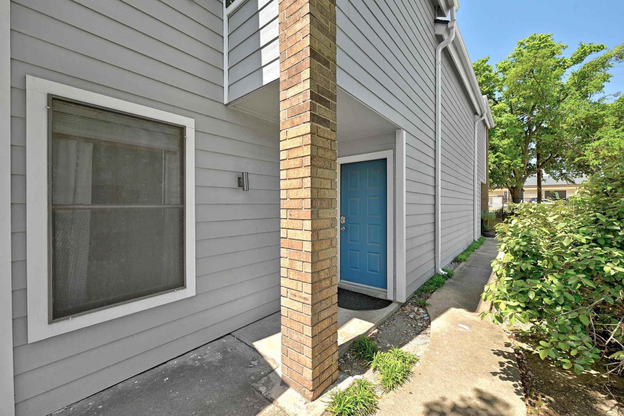 7635 Guadalupe Street, Unit 1002 Austin, TX 78752 - Photo 4 of 27 a backyard of a house with potted plants and garage