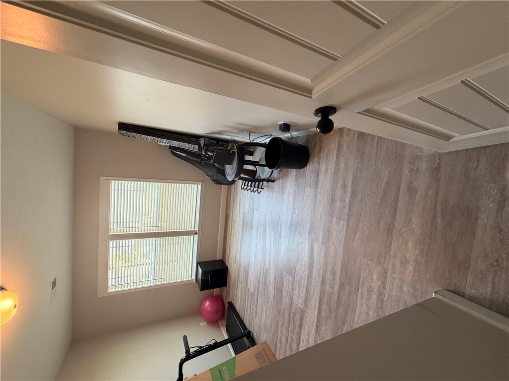 166 Pheasant Ridge Drive Anderson, SC 29626 - Photo 8 of 13 Smooth wood-look flooring and a wide window with blinds define this versatile home gym space.