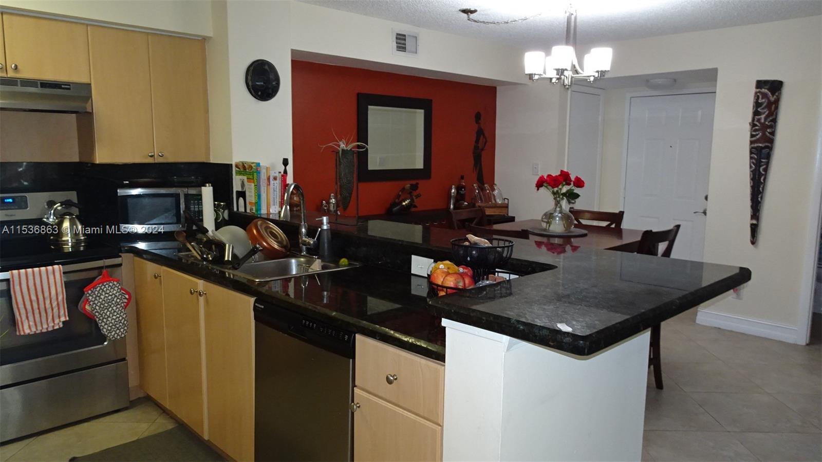 650 South Park Road, Unit 135 Hollywood, FL 33021 - Photo 11 of 36 a kitchen with sink and refrigerator