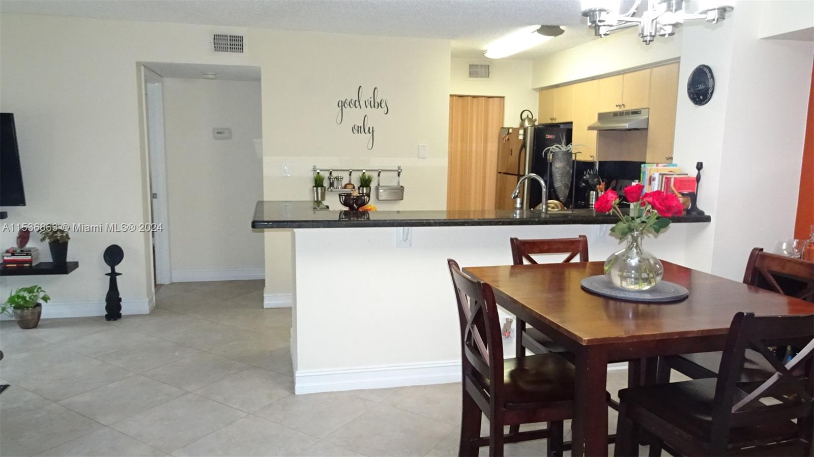 650 South Park Road, Unit 135 Hollywood, FL 33021 - Photo 12 of 36 a view of dining room and kitchen with furniture and a potted plant
