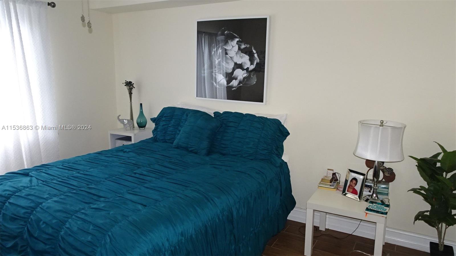 650 South Park Road, Unit 135 Hollywood, FL 33021 - Photo 15 of 36 a bed sitting in a bedroom next to a window