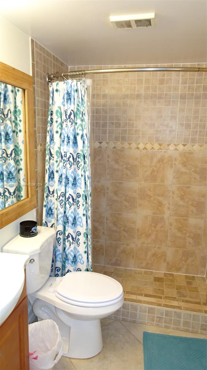 650 South Park Road, Unit 135 Hollywood, FL 33021 - Photo 18 of 36 a white toilet sitting next to a shower curtain