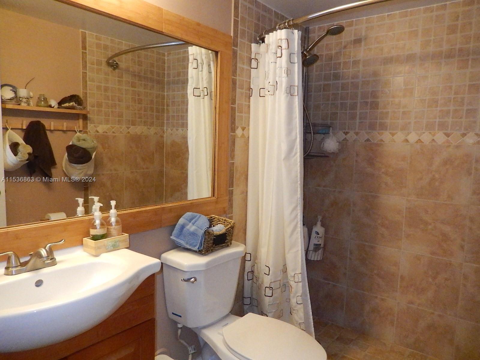 650 South Park Road, Unit 135 Hollywood, FL 33021 - Photo 19 of 36 a bathroom with a sink toilet and shower