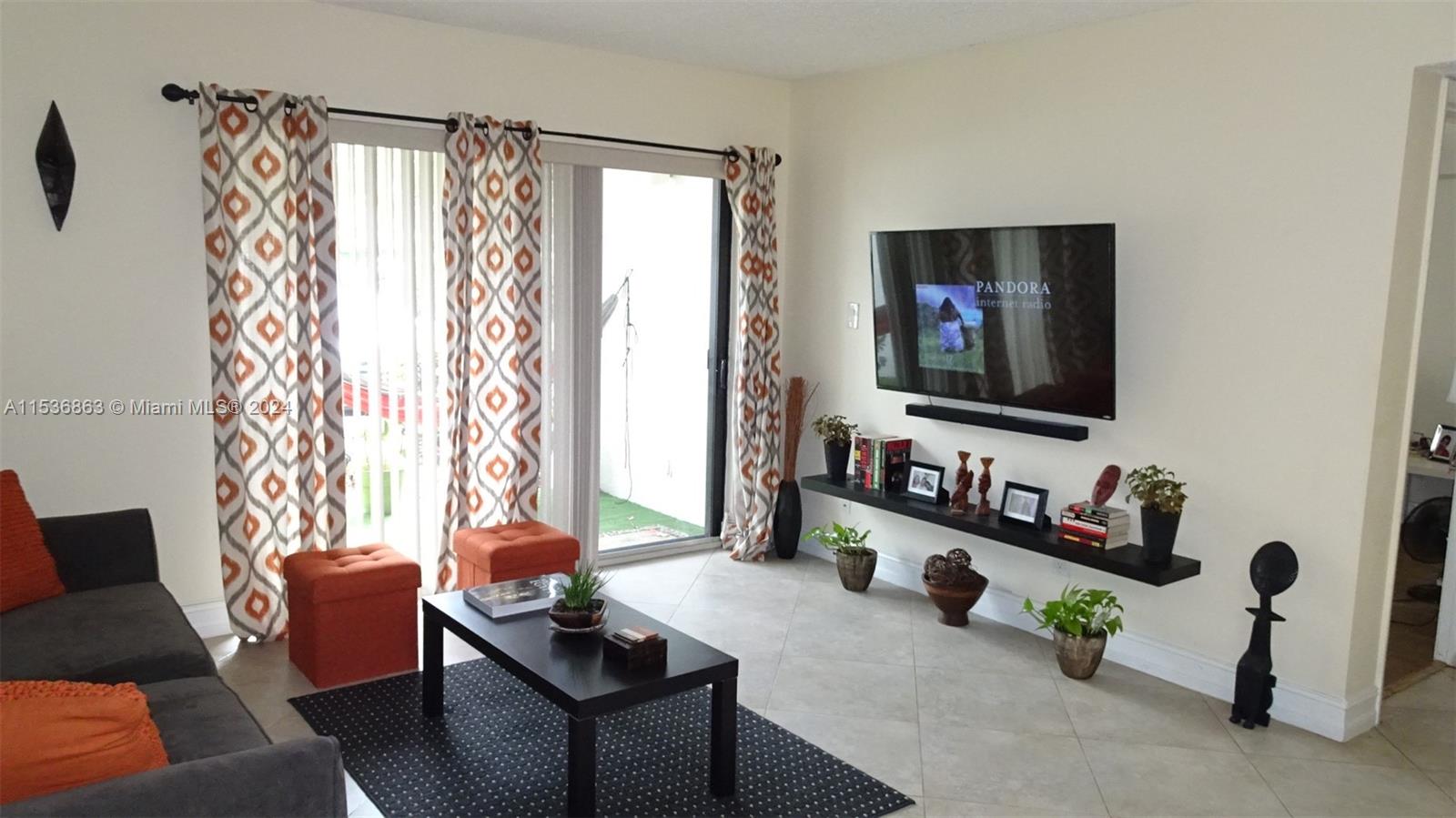 650 South Park Road, Unit 135 Hollywood, FL 33021 - Photo 2 of 36 a living room with furniture and a flat screen tv