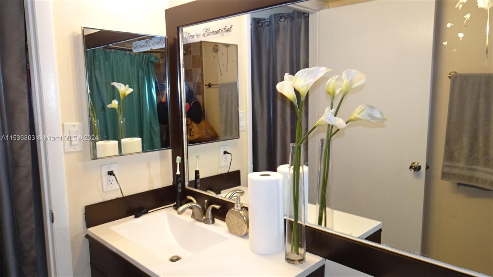 650 South Park Road, Unit 135 Hollywood, FL 33021 - Photo 21 of 36 a bathroom with a sink a mirror and shower