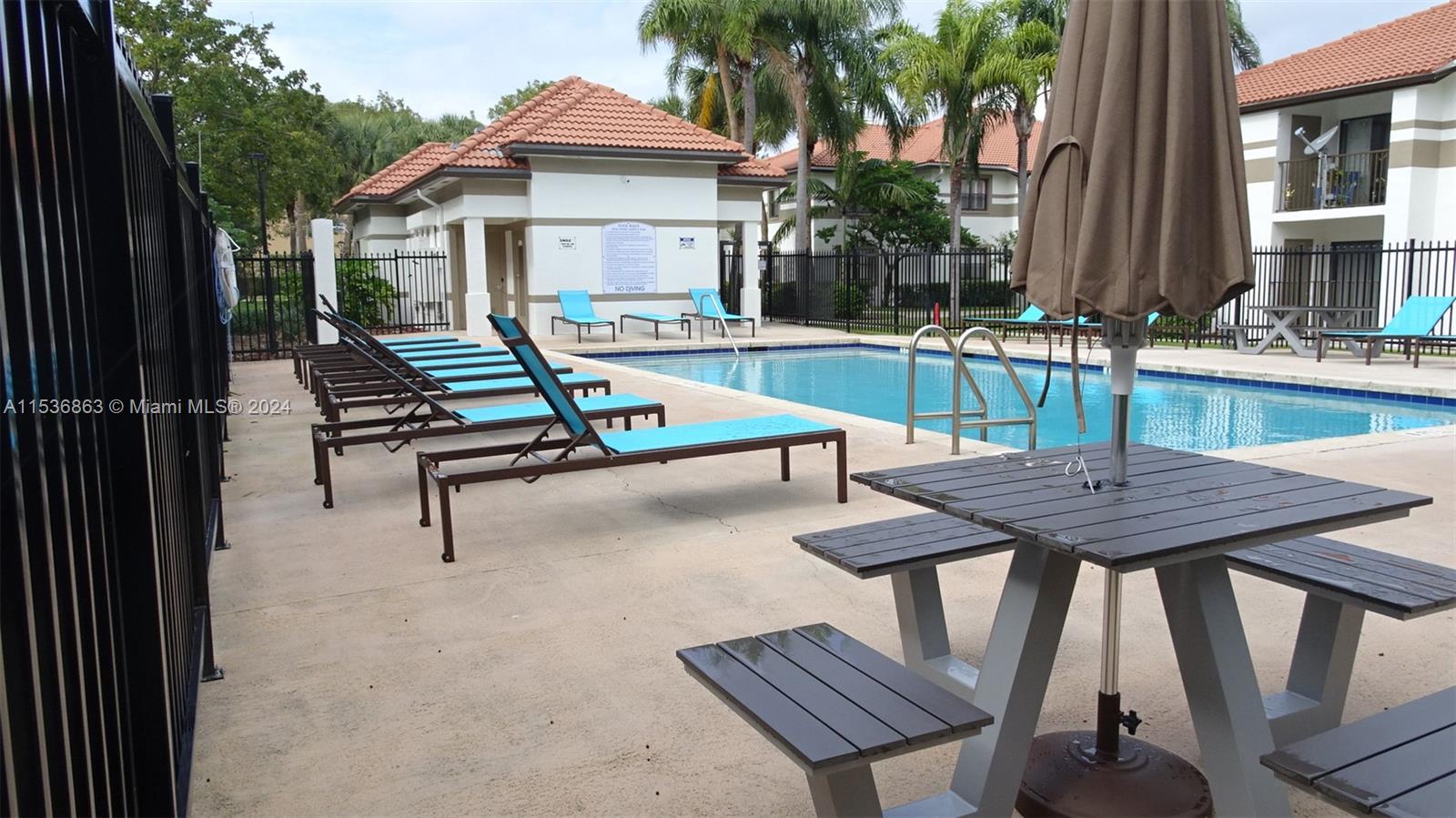 650 South Park Road, Unit 135 Hollywood, FL 33021 - Photo 27 of 36 a view of a patio with a table chairs and a barbeque
