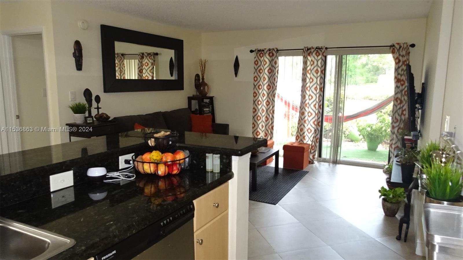 650 South Park Road, Unit 135 Hollywood, FL 33021 - Photo 3 of 36 a living room with furniture and a floor to ceiling window