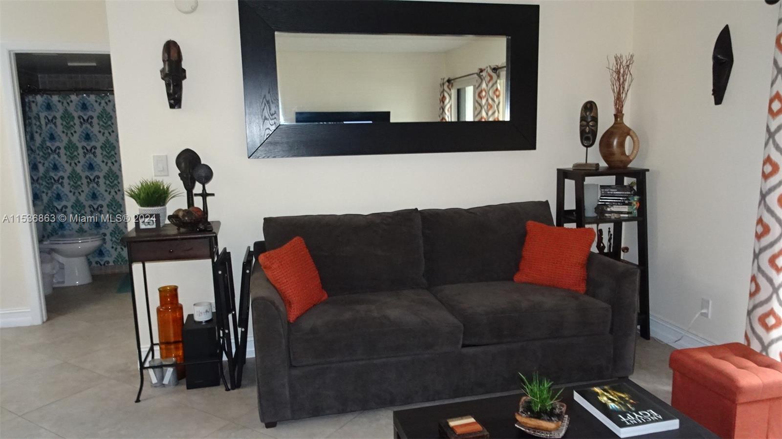 650 South Park Road, Unit 135 Hollywood, FL 33021 - Photo 5 of 36 a living room with furniture and a chandelier